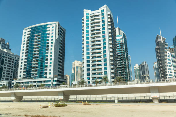 Several high-rise buildings stand tall under a clear blue sky in the bustling cityscape of Dubai.